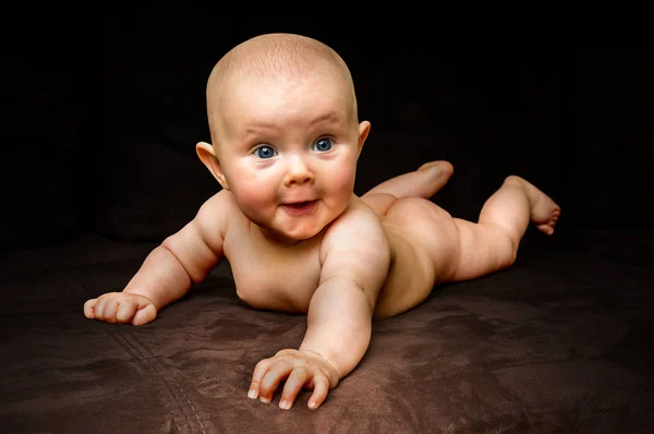 Happy and funny newborn baby on black — Stock Photo, Image