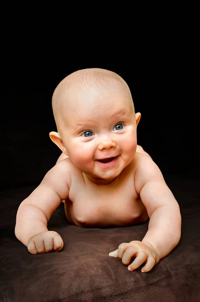 Happy and funny newborn baby on black — Stock Photo, Image