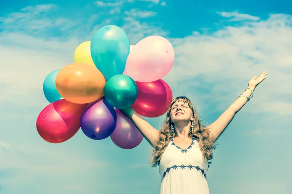 Happy young lady celebrates birthday with balloons — Stock Photo, Image