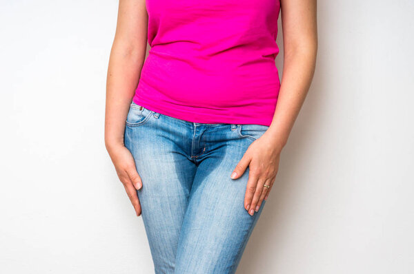 Woman with hands holding her crotch - incontinence concept