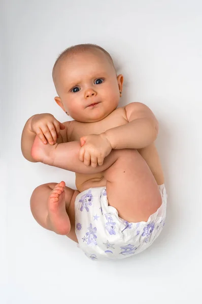 Cute baby in diaper lying on back - isolated on white — Stock Photo, Image