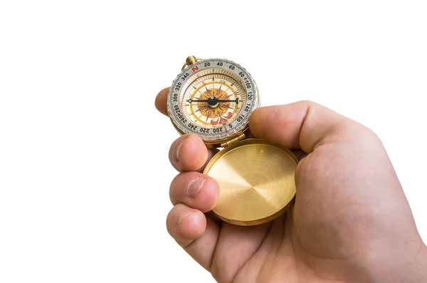 Antieke koperen kompas in een hand geïsoleerd op wit — Stockfoto