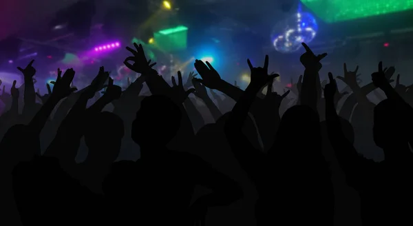 Silhouettes of concert crowd with hands raised at a music disco — Stock Photo, Image