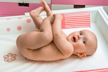 Temiz bir bezi için bekleyen şirin bebek kız