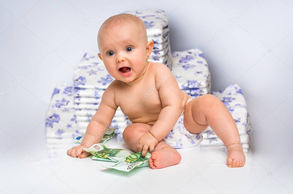 Cute baby with money isolated on blurry diapers background