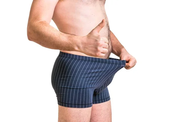 Mann schaut in seine Unterwäsche und zeigt Daumen hoch — Stockfoto