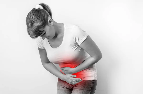 Woman with menstrual pain is holding her aching belly — Stock Photo, Image