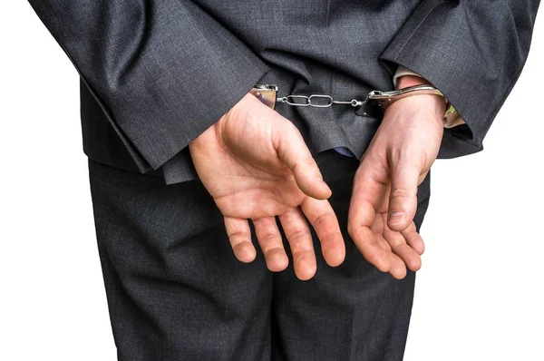 Arrested businessman in handcuffs with hands behind back — Stock Photo, Image