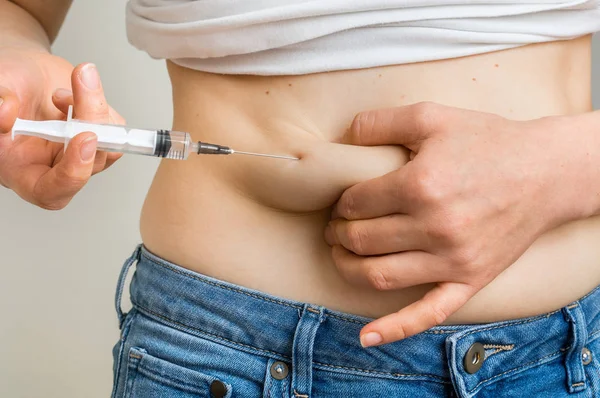 Diabetic woman with syringe inject insulin to her belly — Stock Photo, Image