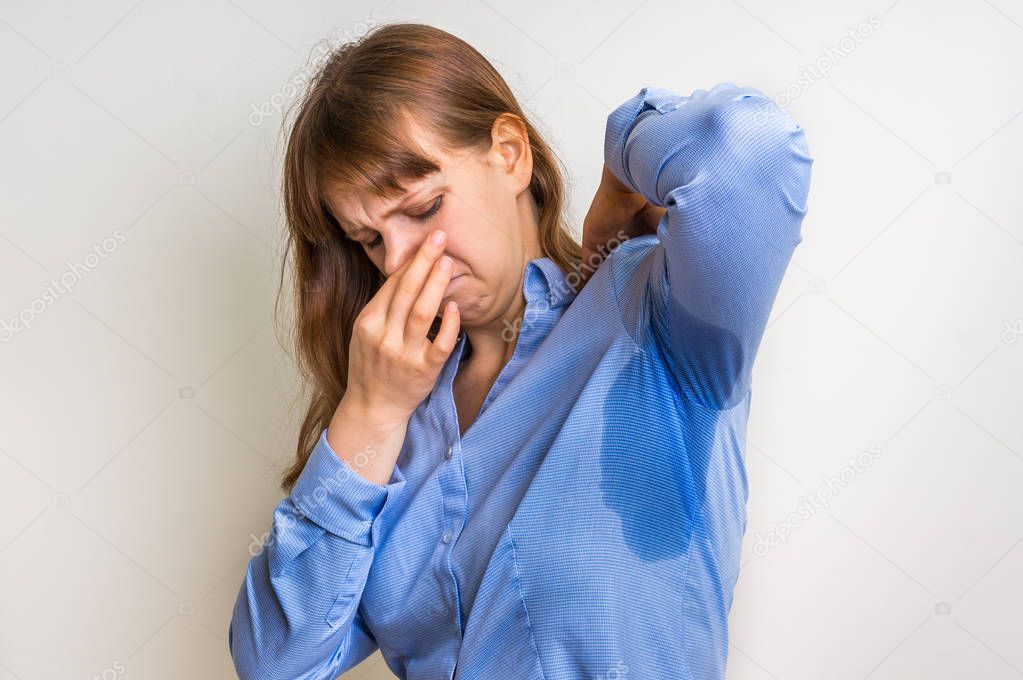 Woman with sweating under armpit