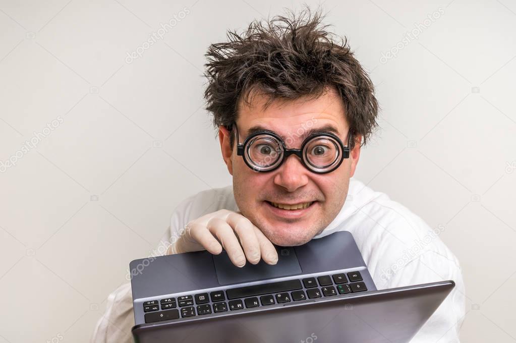 Crazy scientist with laptop working in his laboratory