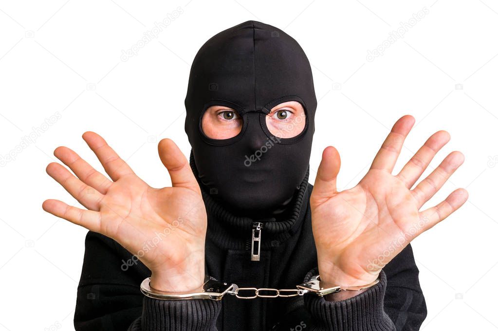 Masked thief in handcuffs isolated on white