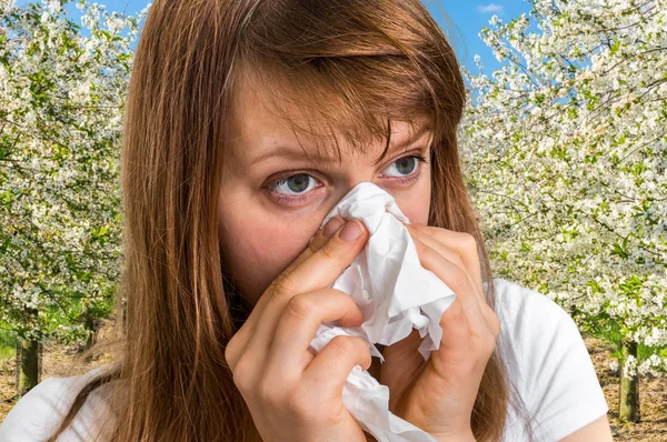 Woman with allergy near flowering trees — Stock Photo, Image