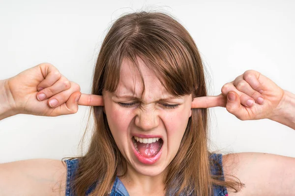 Woman covering her ears to protect from loud noise — Stock Photo, Image