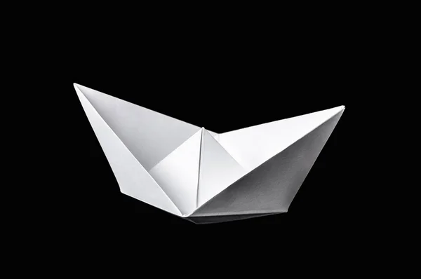 Origami boat isolated on black background