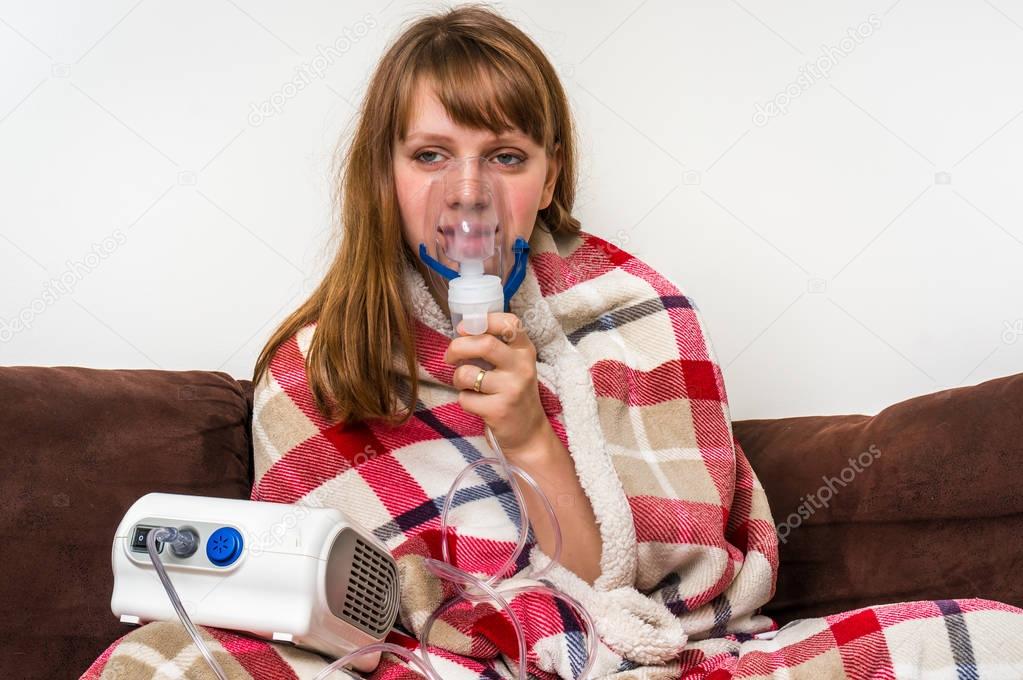 Woman with flu or cold symptoms making inhalation