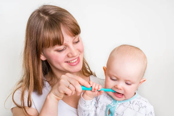 Mother and her baby brushing teeth together Stock Photo