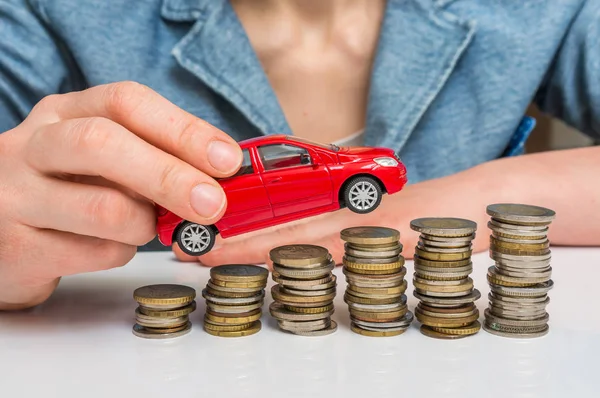 Businesswoman and toy car on coin stack — Stock Photo, Image