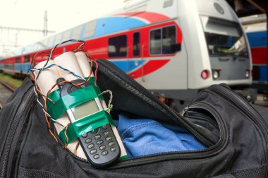 Dynamite bomb with phone in terrorist bag on train station clipart