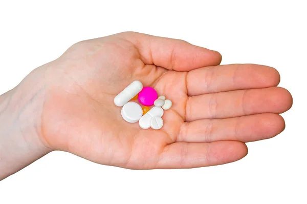 Pile of pills in female hand isolated on white — Stock Photo, Image