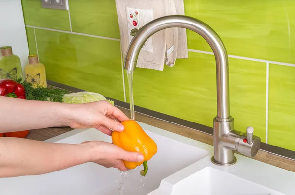 Woman washing yellow pepper for salad - fresh vegetables — Stock Photo, Image
