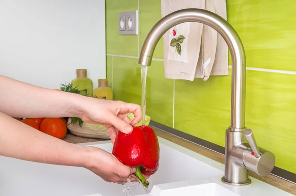 Woman washing red pepper for salad - fresh vegetables — Stock Photo, Image