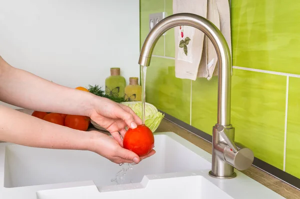 Woman washing tomato for salad - fresh vegetables — Stock Photo, Image