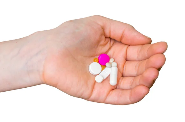 Куча таблеток в женской руке, изолированных на белом — стоковое фото