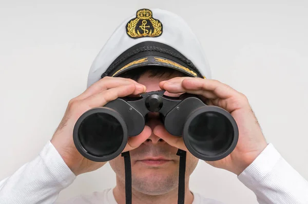 Captain looks through a binoculars — Stock Photo, Image