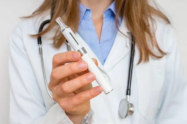 El médico ofrece un cigarrillo electrónico o un vaporizador —  Fotos de Stock