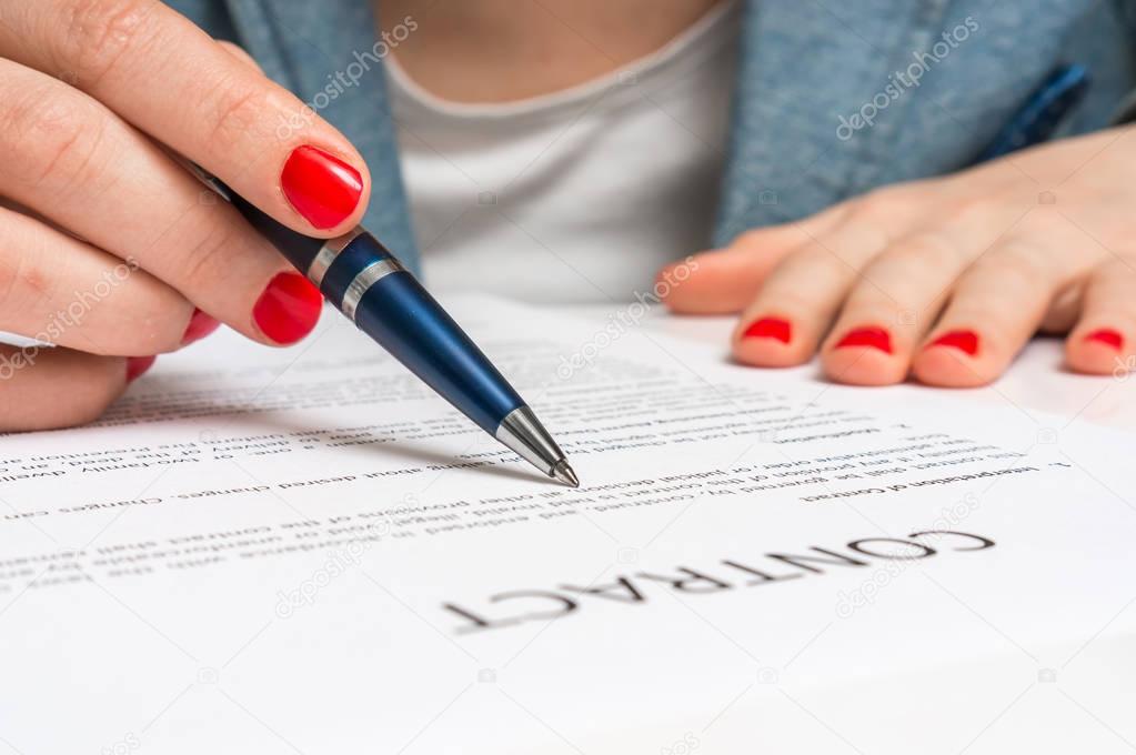 Business woman signing contract document in office