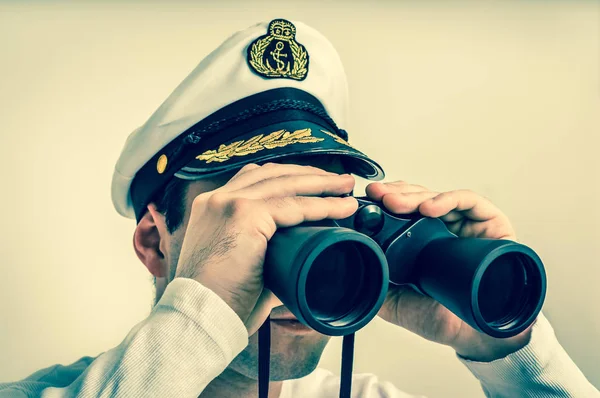 Captain looks through a binoculars - retro style — Stock Photo, Image
