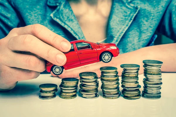 Businesswoman and toy car on coin stack - retro style — Stock Photo, Image