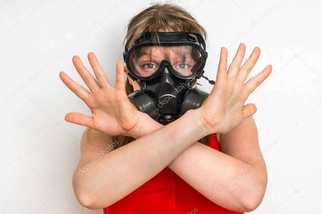 Business woman with gas mask is showing negative gesture