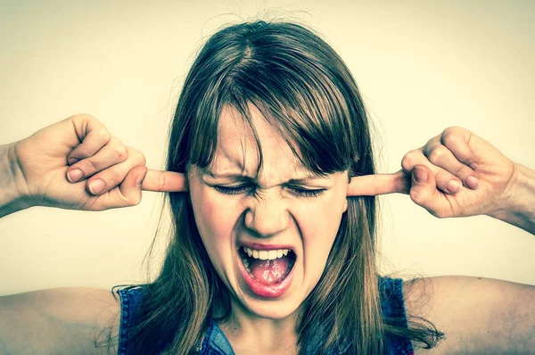 Woman covering her ears to protect from loud noise — Stock Photo, Image