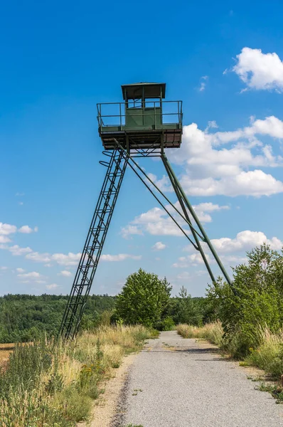 Remains of iron curtain with watchtower — Stock Photo, Image