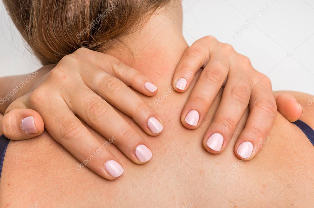 Woman making self massage of her neck