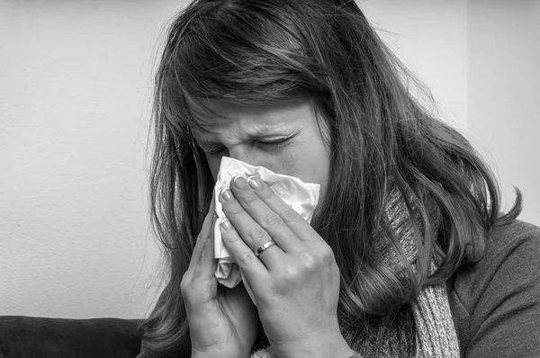 Sick woman having flu and sneezing into handkerchief — Stock Photo, Image