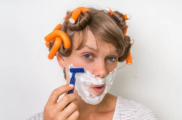 Young woman shaves her face with foam and razor — Stock Photo, Image