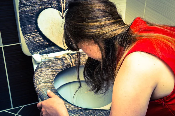 Woman vomiting in the bathroom - retro style — Stock Photo, Image