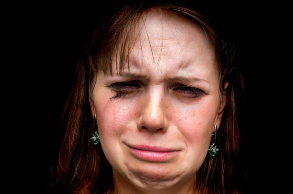 Close up portrait of a crying woman isolated on black — Stock Photo, Image