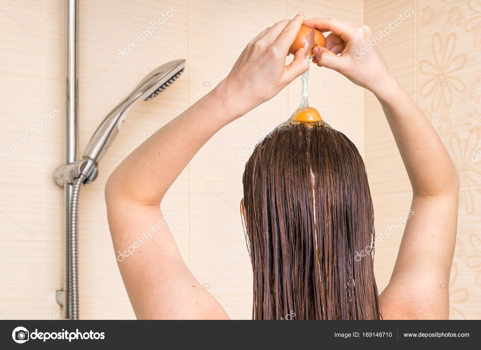 Woman Applying Egg Conditioner On Her Hair In Bathroom Stock