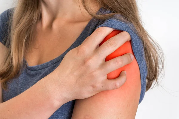 肩痛的女人抱着她酸痛的手臂 — 图库照片