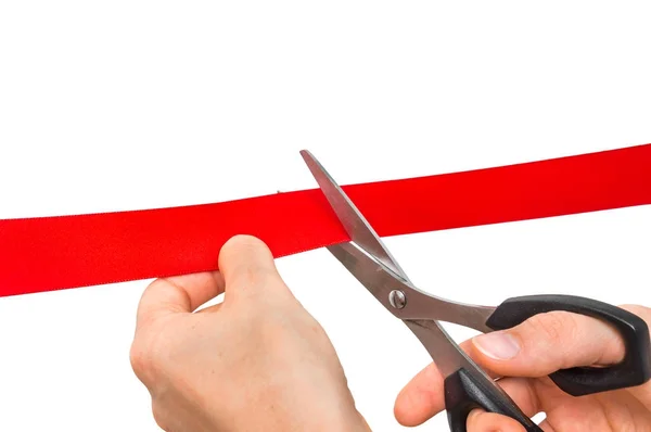 Hand with scissors cutting red ribbon - opening ceremony — Stock Photo, Image