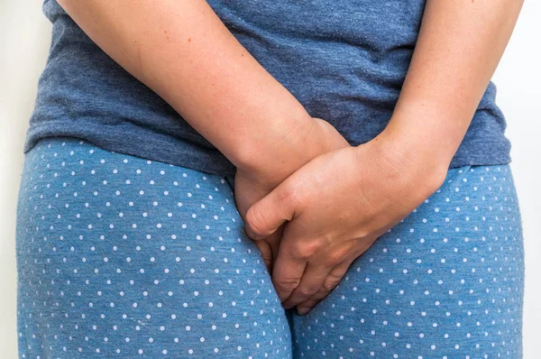 Woman with incontinence problem is holding her crotch — Stock Image Woman with incontinence problem is holding her crotch Stock Photo