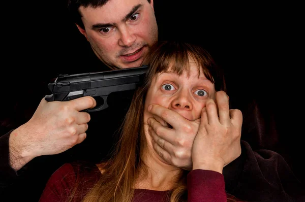 stock image Man with a handgun aiming on a head his victim