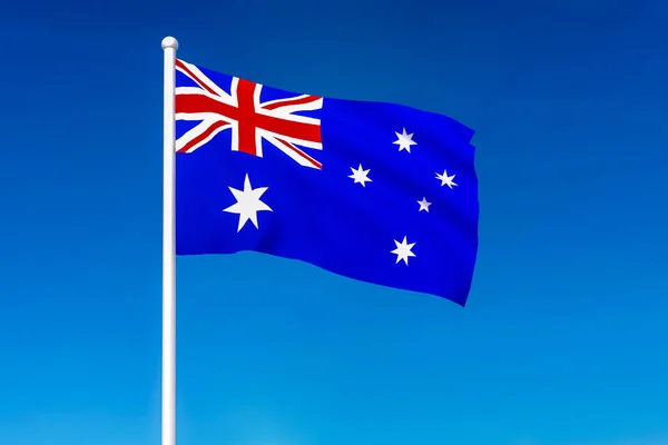 푸른 하늘 위에서 오스트레일리아의 깃발을 흔들며 — 스톡 사진