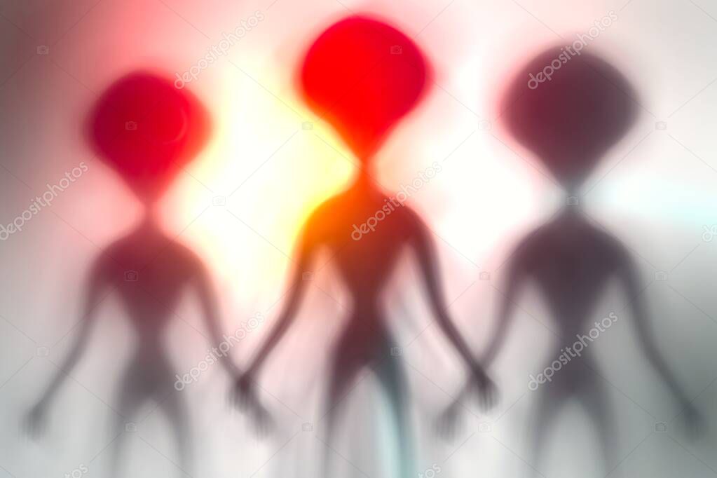 Silhouettes of spooky aliens and bright light on behind them