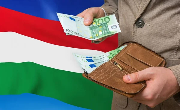 Investing money to Hungary. Rich man with a lot of money.