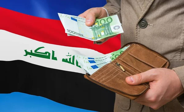 Investing money to Iraq. Rich man with a lot of money.